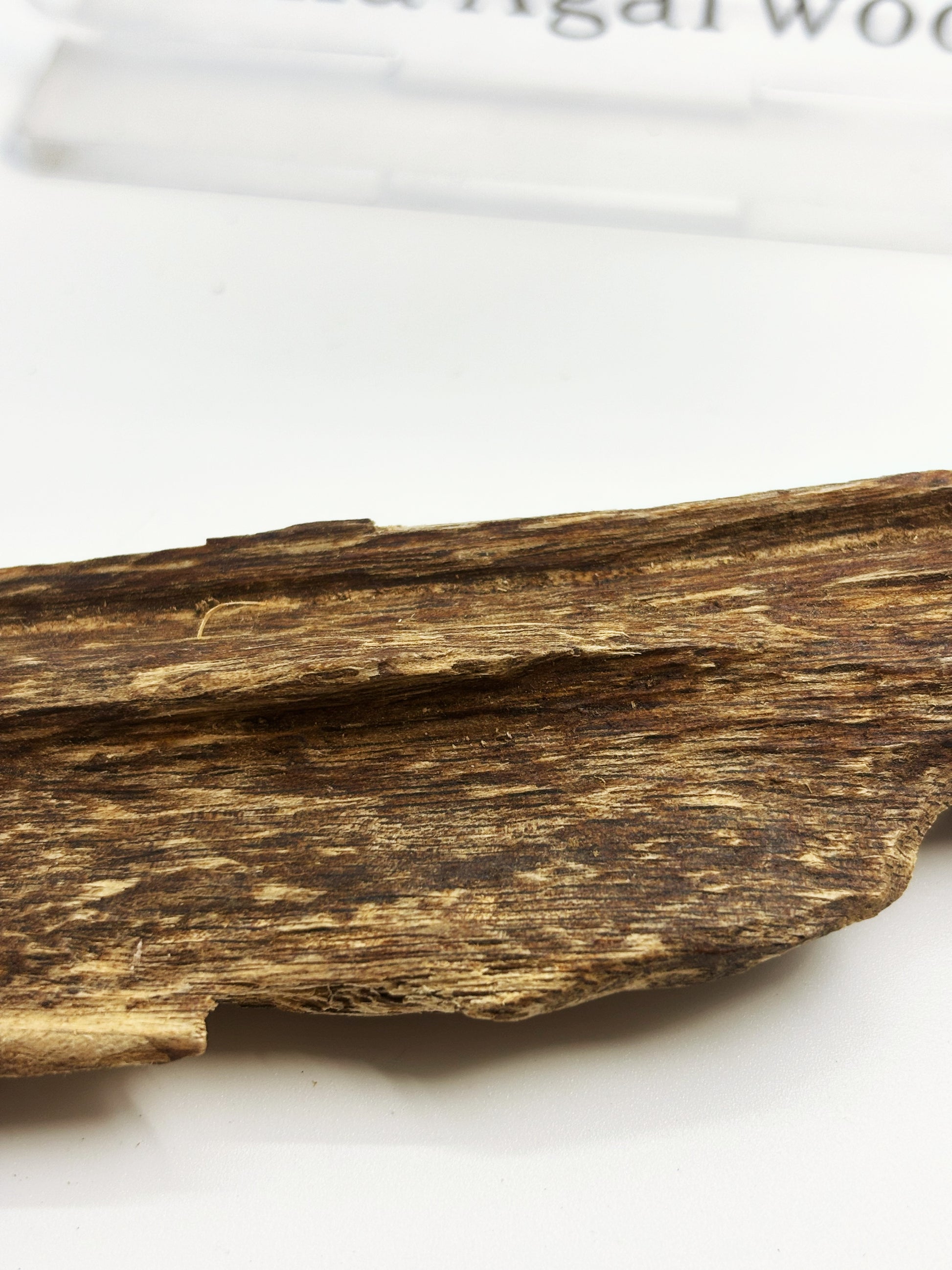 Factory artisans manually trimming white wood from 4A insect-hole Hainan Oud chunks