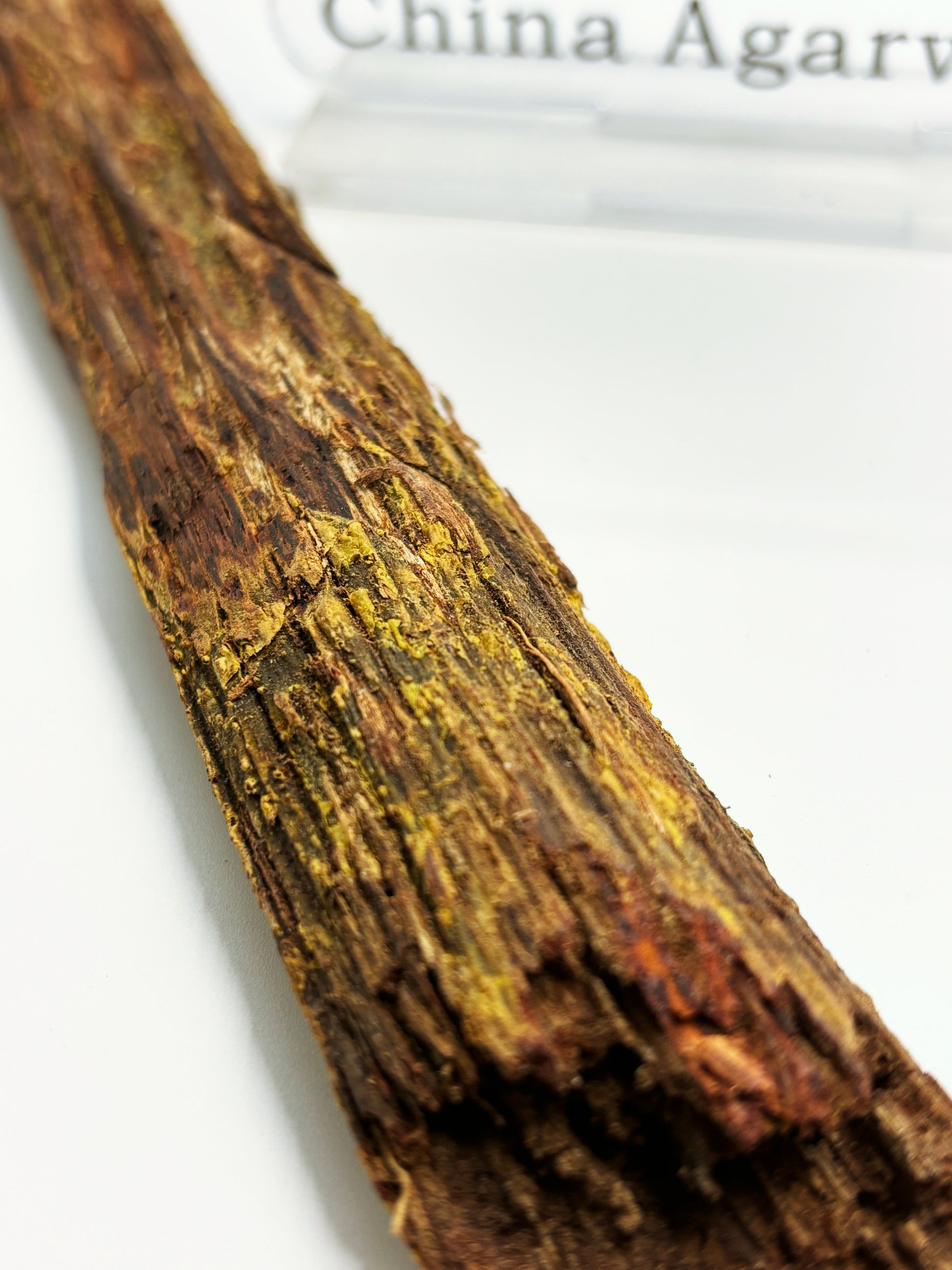 Close-up of premium Hainan sandalwood showing its rich Imperial Rose Resin texture