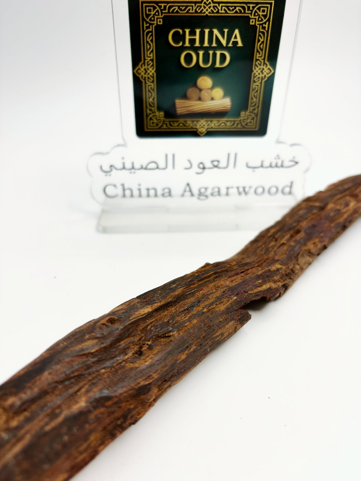 Close-up of premium small-leaf Hainan sandalwood showing ultra-dense oil-saturated grain